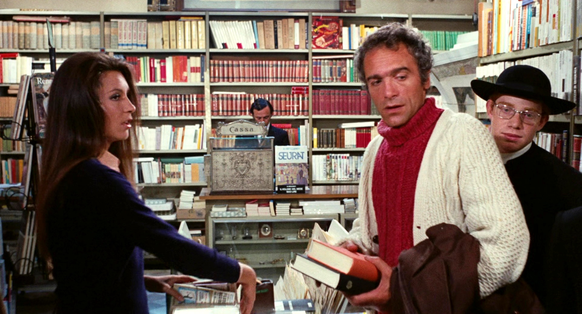 Il tuo vizio (1972) Young priest in library.jpg